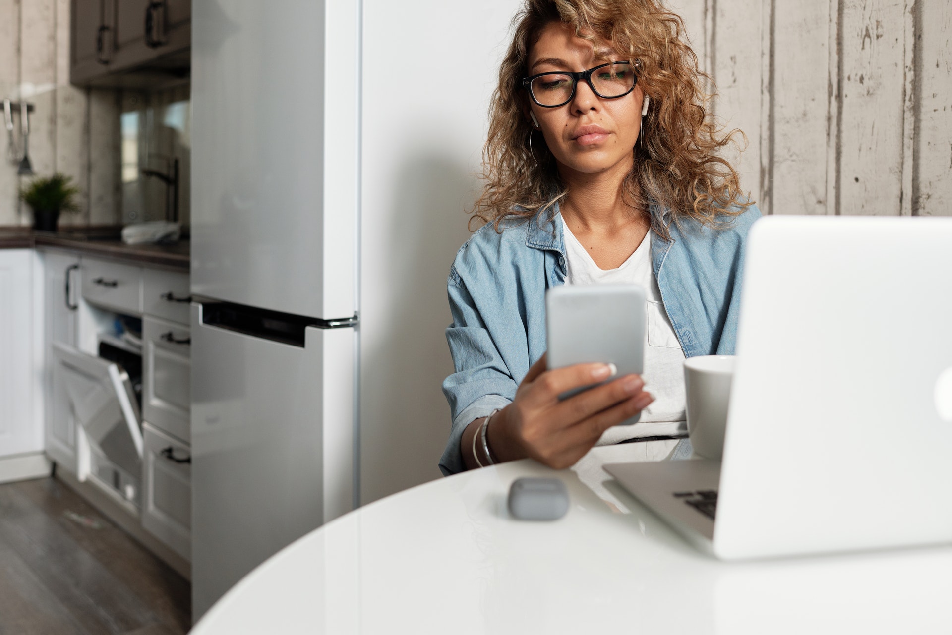 woman with phone at computer