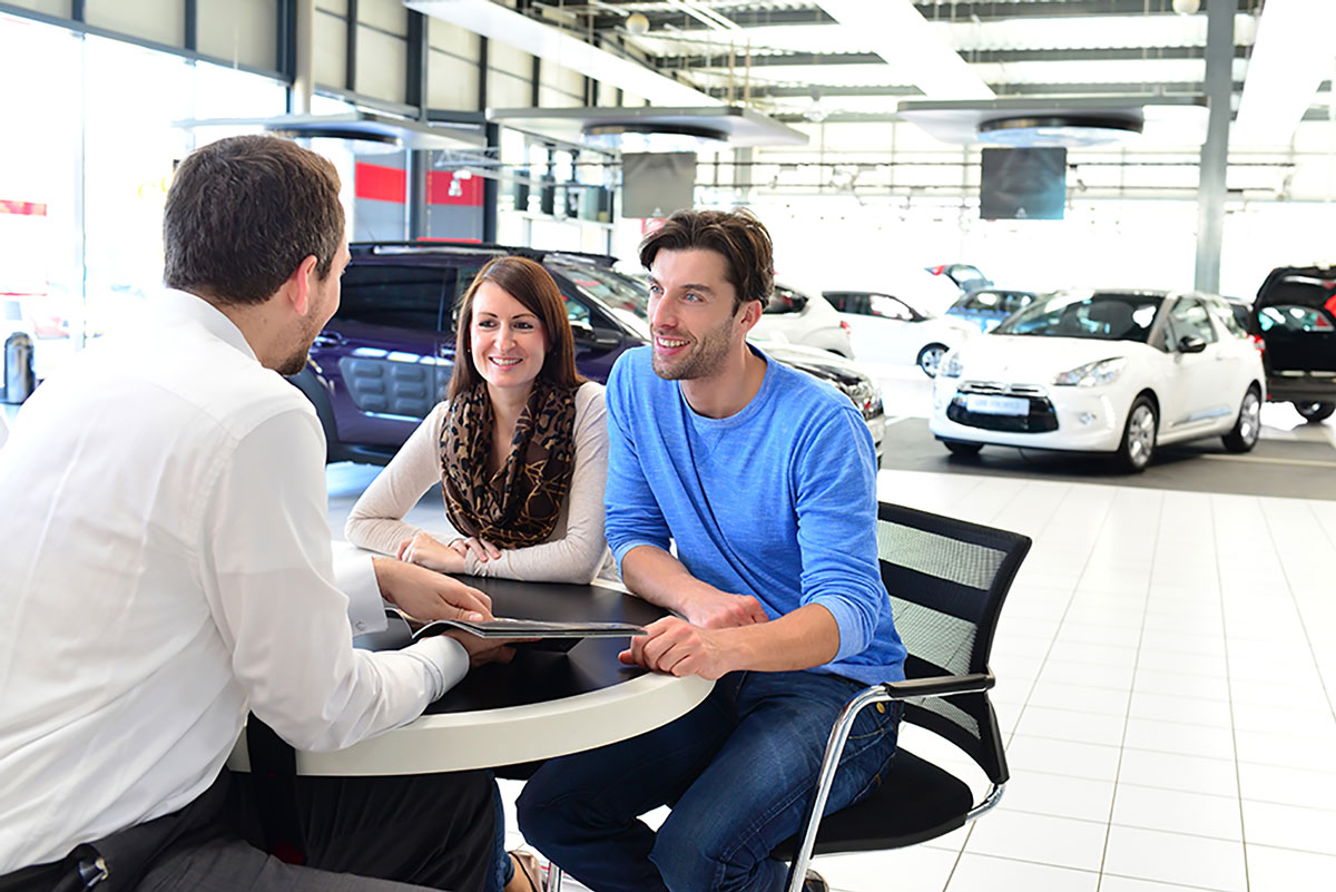 couple with car salesman